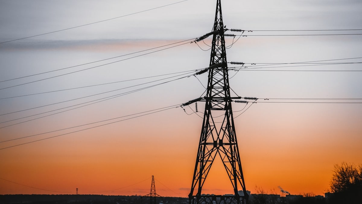 silhouette of electric tower during sunset
